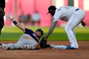 Minnesota Twins' Josh Donaldson beats the tag by Kansas City Royals second baseman Hanser Alberto after hitting a double during the first inning of a 