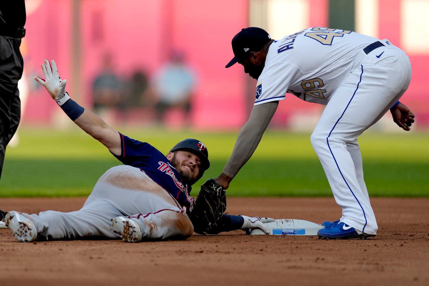 Minnesota Twins' Josh Donaldson beats the tag by Kansas City Royals second baseman Hanser Alberto after hitting a double during the first inning of a baseball game Friday, July 2, 2021, in Kansas City, Mo. (AP Photo/Charlie Riedel)