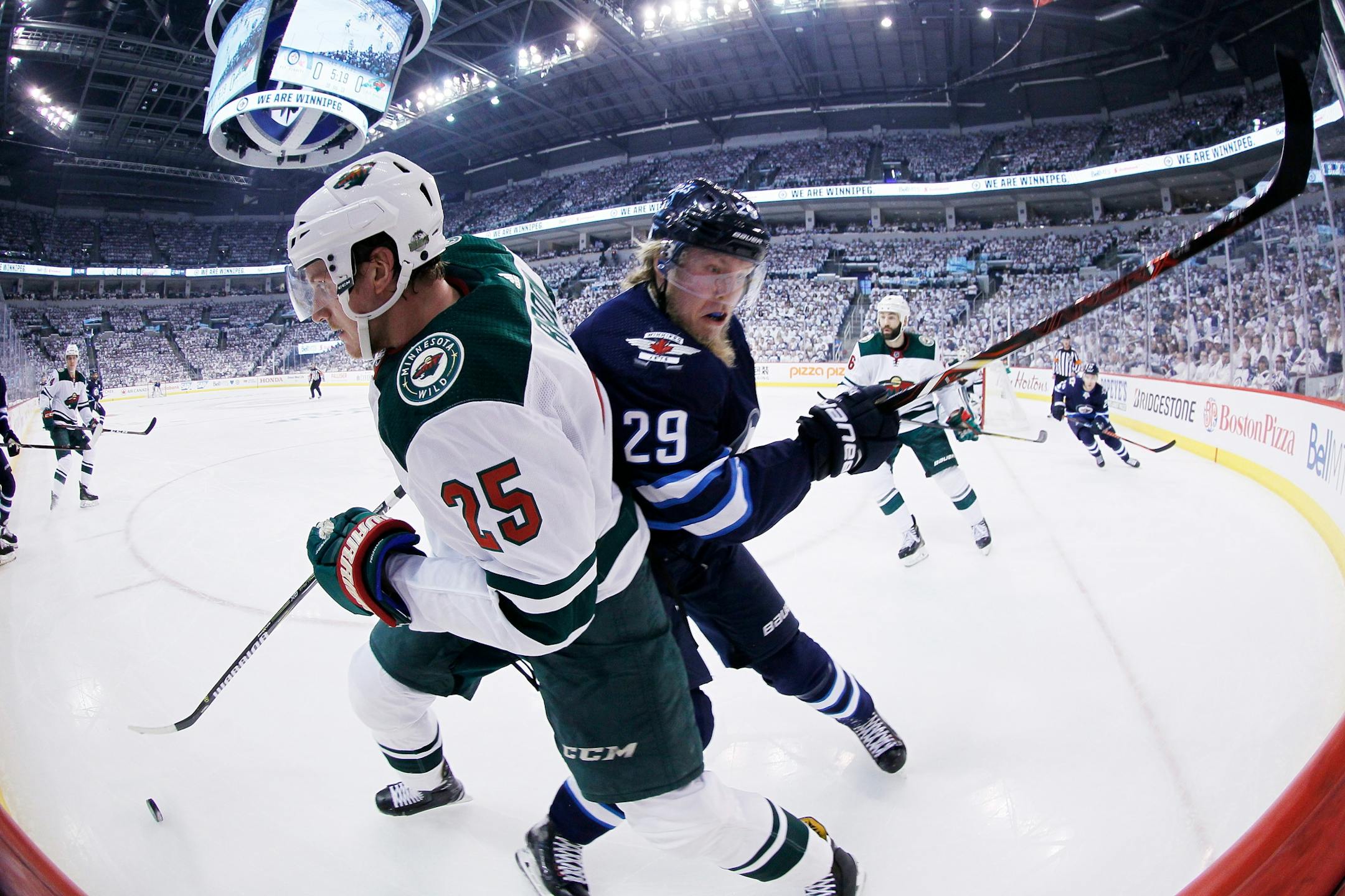 Winnipeg Jets' Patrik Laine (29) checks Minnesota Wild's Jonas Brodin (25) during the second period of Game 1 in an NHL hockey first-round playoff series Wednesday, April 11, 2018, in Winnipeg, Manitoba.