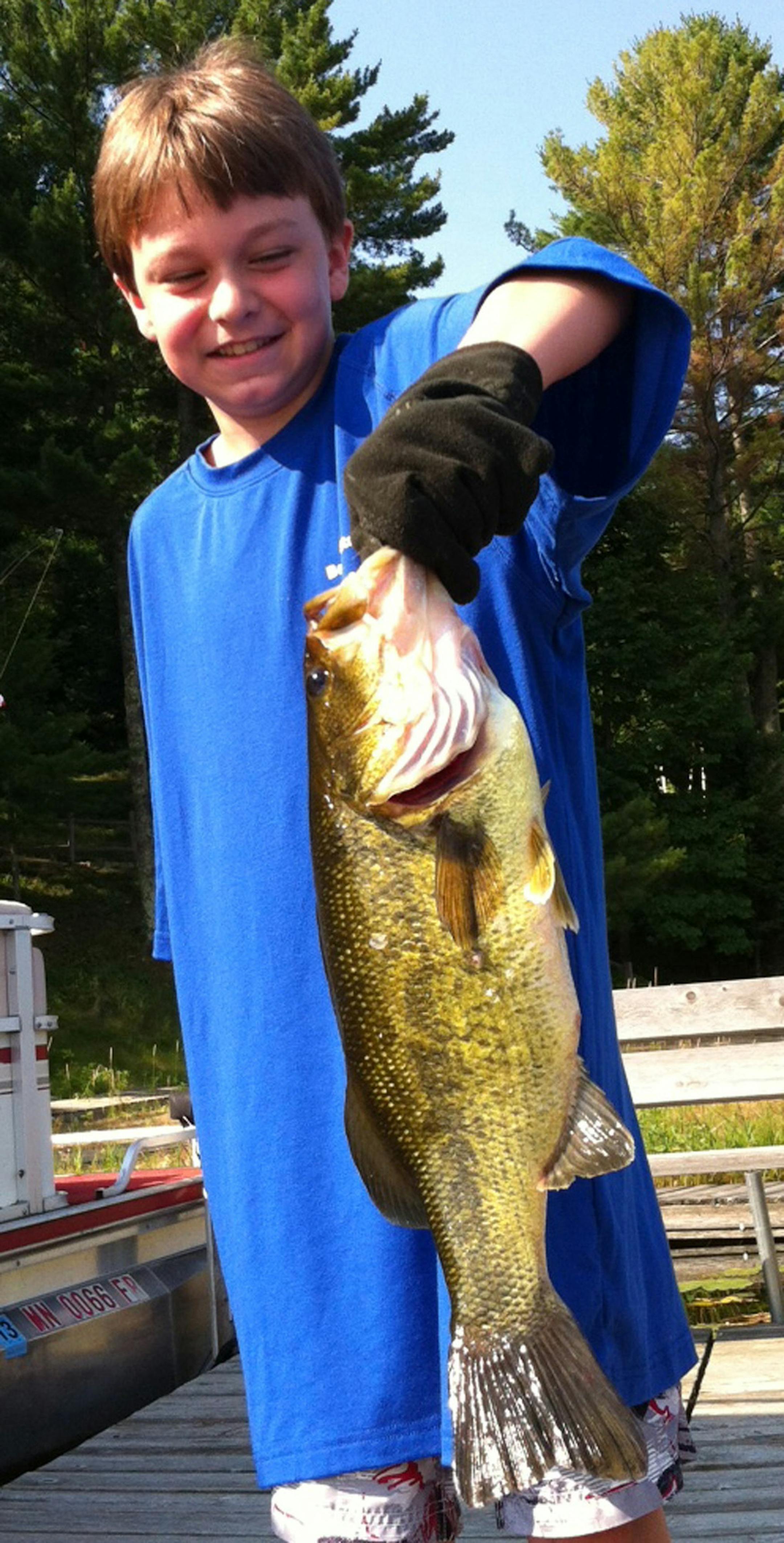 Big bass -- Grant Kirt, 11, of Maple Grove, caught this 24-inch largemouth bass from the dock on Lower Whitefish Lake. He landed it by himself, without a net. He released the fish.