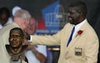 Randall McDaniel of the Minnesota Vikings and the Tampa Bay Buccaneers touches his bust after unveiling it during the Pro Football Hall of Fame Class 