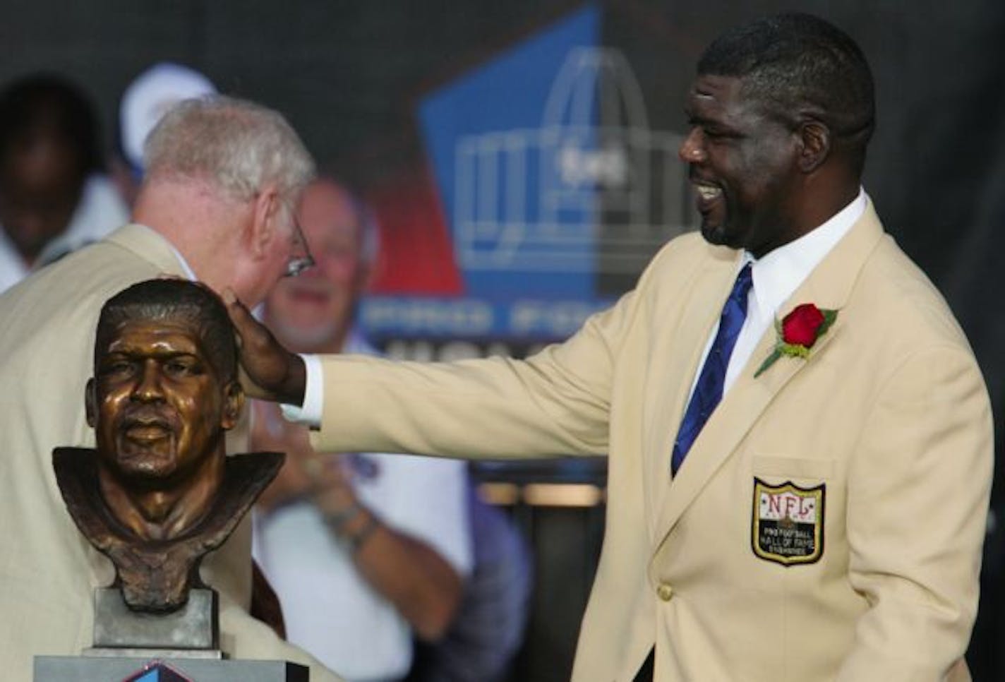 Randall McDaniel of the Minnesota Vikings and the Tampa Bay Buccaneers touches his bust after unveiling it during the Pro Football Hall of Fame Class of 2009 Enshrinement ceremony at Fawcett Stadium in Canton, Ohio, Saturday, Aug. 8, 2009.