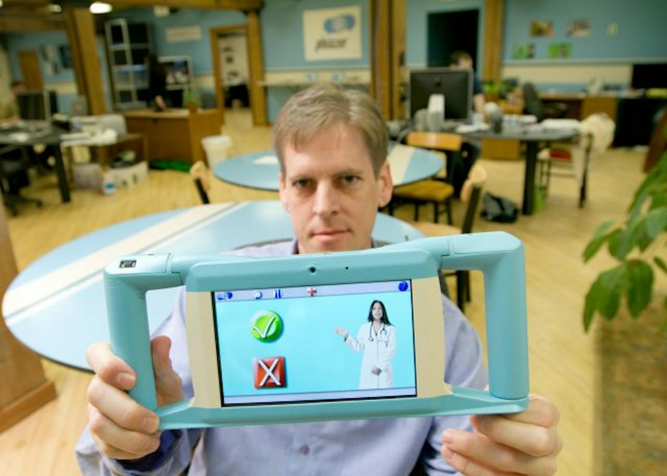 02.17.11 Mat Johnson, founder and CEO of GeaCom, Inc., holds the Phrazer, a device that health care professionals can use to overcome language barriers with patients, in the company's Duluth office, on February 17, 2011. The Phrazer collects the patient's medical history and symptoms, and can determine the language the patient speaks in less than 20 seconds. "It's a big honor," said Johnson, of having the Phrazer completed and in use. "People's lives are being saved right now. Everyone wants the