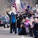 People lined the streets of downtown Glenwood on April 23 during the funeral procession for Pope County deputy Josh Owen, who had been fatally shot wh