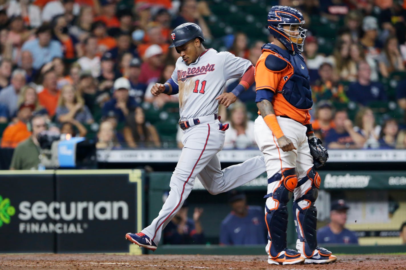 The Twins' Jorge Polanco scores on a single by Luis Arraez behind Astros catcher Martin Maldonado during the sixth inning