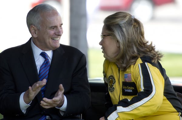 Sep5. 2012: Gov. Mark Dayton and Lt. Gov. Yvonne Prettner Solon, who is dressed for the skydive she made onto the State Capitol lawn.
