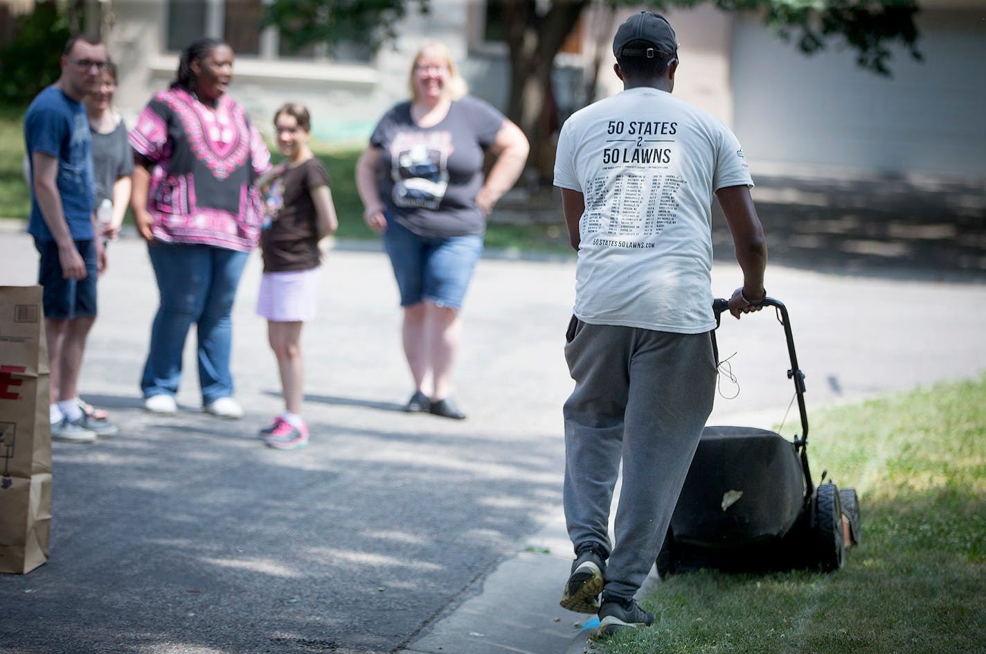 After mowing a lawn in St. Paul, Rodney Smith mowed his third lawn of the day in his 48th state, Thursday, July 12, 2018 in Hopkins, MN. Smith said he received a call from God to help others by mowing his way across country. He also receives help from young boys who volunteer to help him. ] ELIZABETH FLORES � liz.flores@startribune.com