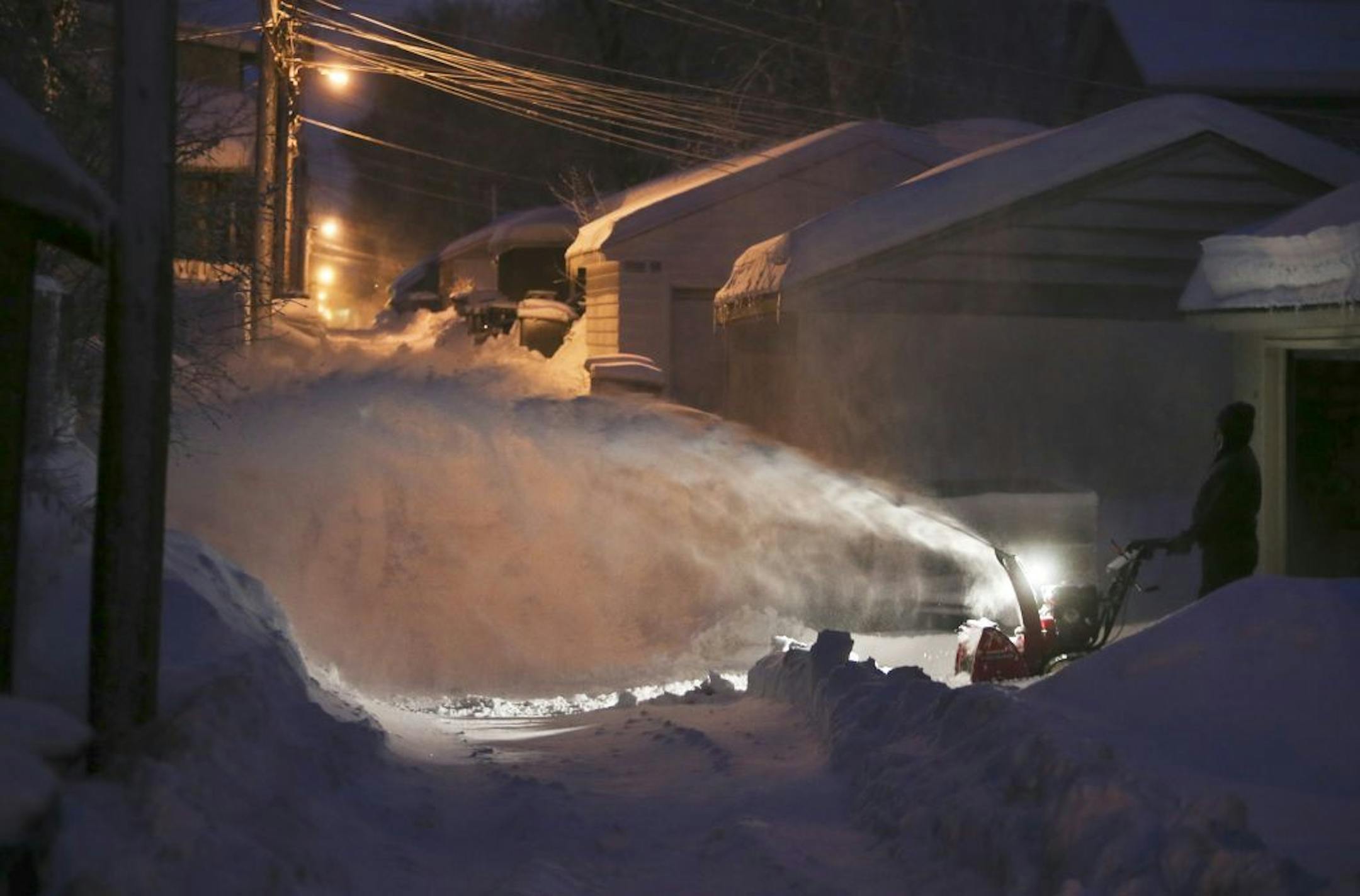 Residents dug out from the season's largest snow storm of the year on Friday, Feb. 21, 2014, in and around the metro. Here, a man blows snow in an alley off of Nicollet Ave. S. in Minneapolis.