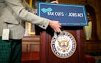 A sign is applied onto a lectern before a news conference following the House passing the Republican-led tax reform bill, on Capitol Hill in Washingto