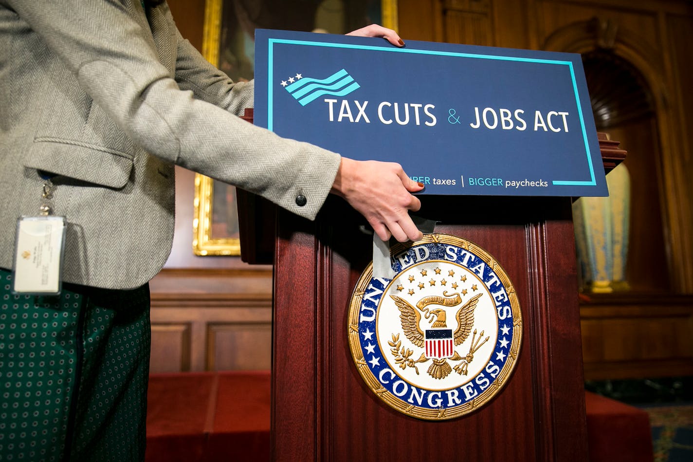 A sign is applied onto a lectern before a news conference following the House passing the Republican-led tax reform bill, on Capitol Hill in Washington, Nov. 16, 2017.