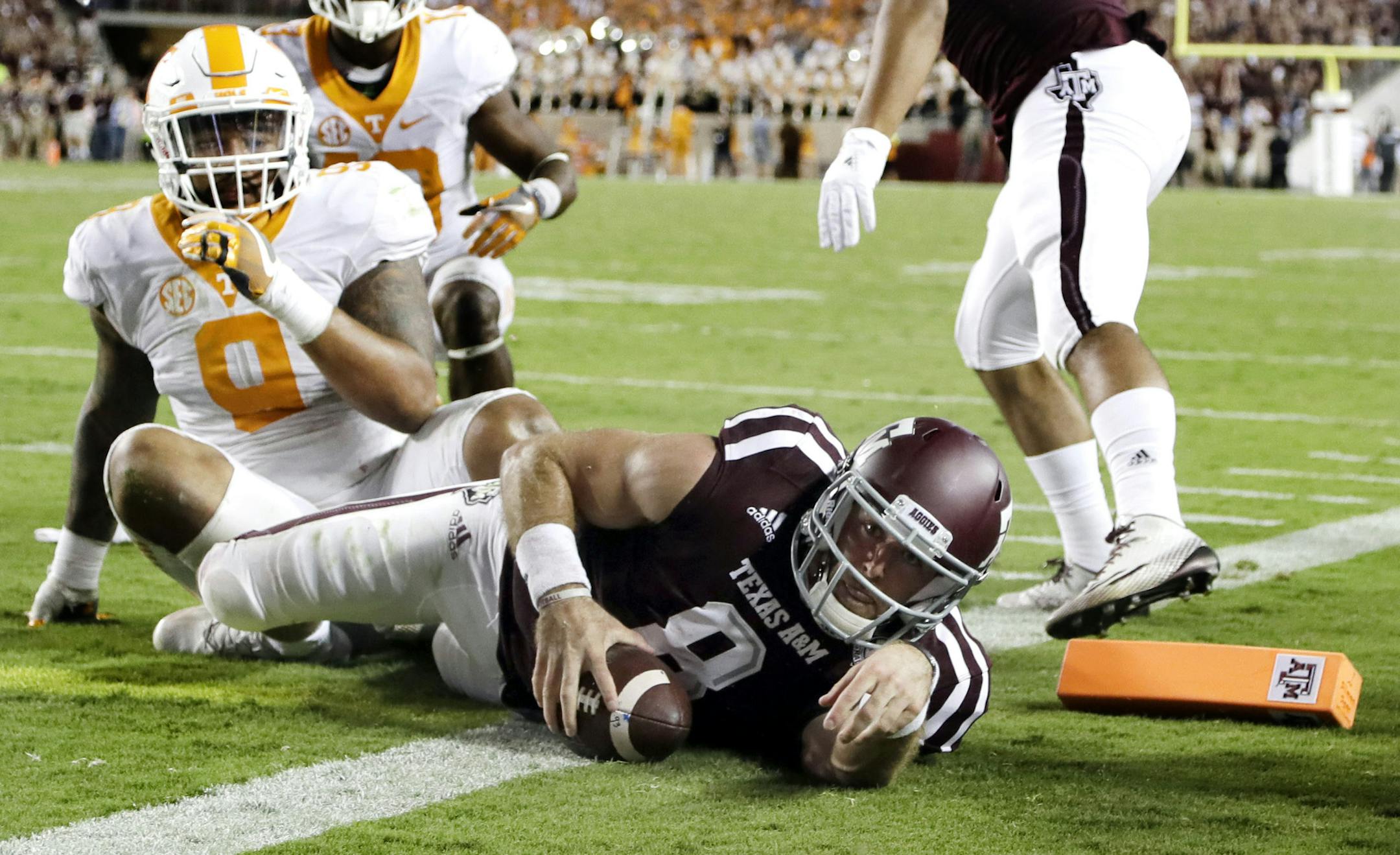 Texas A&M quarterback Trevor Knight (8) rushes for a touchdown as Tennessee defensive end Derek Barnett (9) defends during overtime in an NCAA college football game Saturday, Oct. 8, 2016, in College Station, Texas. Texas A&M won 45-38 in overtime. (AP Photo/David J. Phillip)