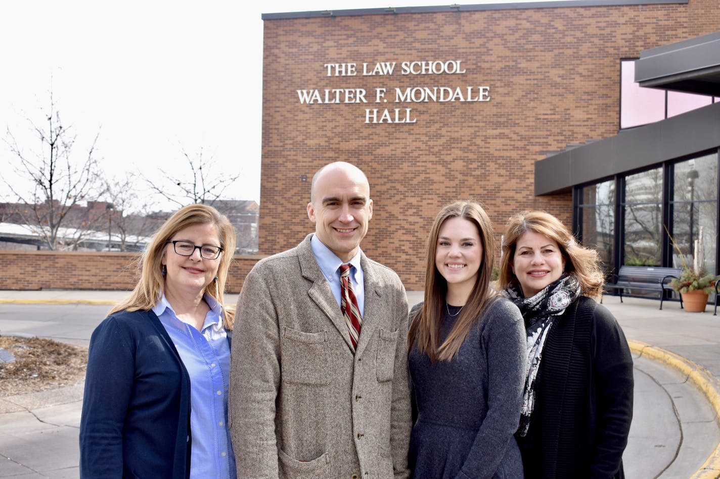 Staff of the Innocence Project of Minnesota on move-in day, April 1. (From left to right) executive director Sara Jones '88, staff attorney Jim Mayer '01, advancement and operations manager Emily Luxem, and legal director Julie Jonas '95. (All of the current legal staff are alums of the University of Minnesota Law School. In addition, Jones&#x2019;s father and nephew are both graduates of the school, making her the second of three generations of alums.) (Photo by Luke Johnson)