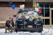 Zach Osterberg, of the Savage Fire Department, was overwhelmed with emotion and hugged his son Lincoln Osterberg as they paid their respect on three m