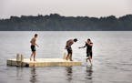 Keanu Artishon, from right, 15, jumped into Lake Harriet as his brother Adrian Artishon, 14, and cousin Moy Artishon, 14, all of Minneapolis, watch hi
