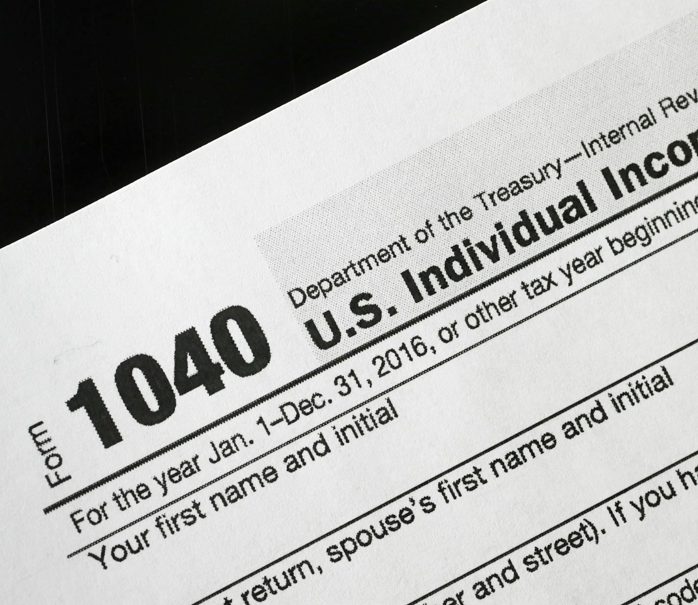 FILE - I this Jan. 10, 2017 file photo, a 1040 tax form appears on display in New York. Last year the IRS issued 111 million refunds, with an average refund of $2,860. More than 70 percent of taxpayers will get refunds this year, the IRS estimates. (AP Photo/Mark Lennihan)