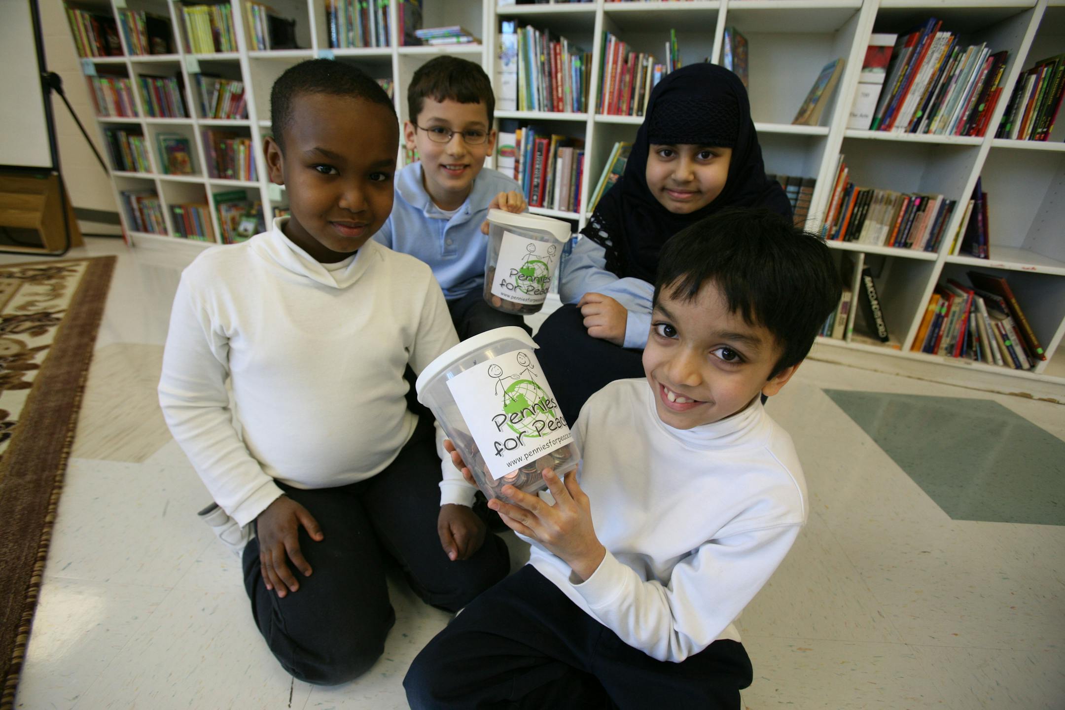 Students at Al-Amal School in Fridley are raising money through the end of the month for Pennies for Peace to help fund schools in Pakistan and Afghanistan. Pictured, front, from left, are third-graders Adam Adan and Shoaib Siddiqui; back, from left, are fourth-graders Jaffer Muhawesh and Ayesha Khan.