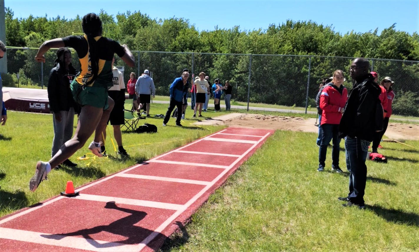 Park Center junior LauBenra Ben in the midst of a triple jump in during a recent track meet.