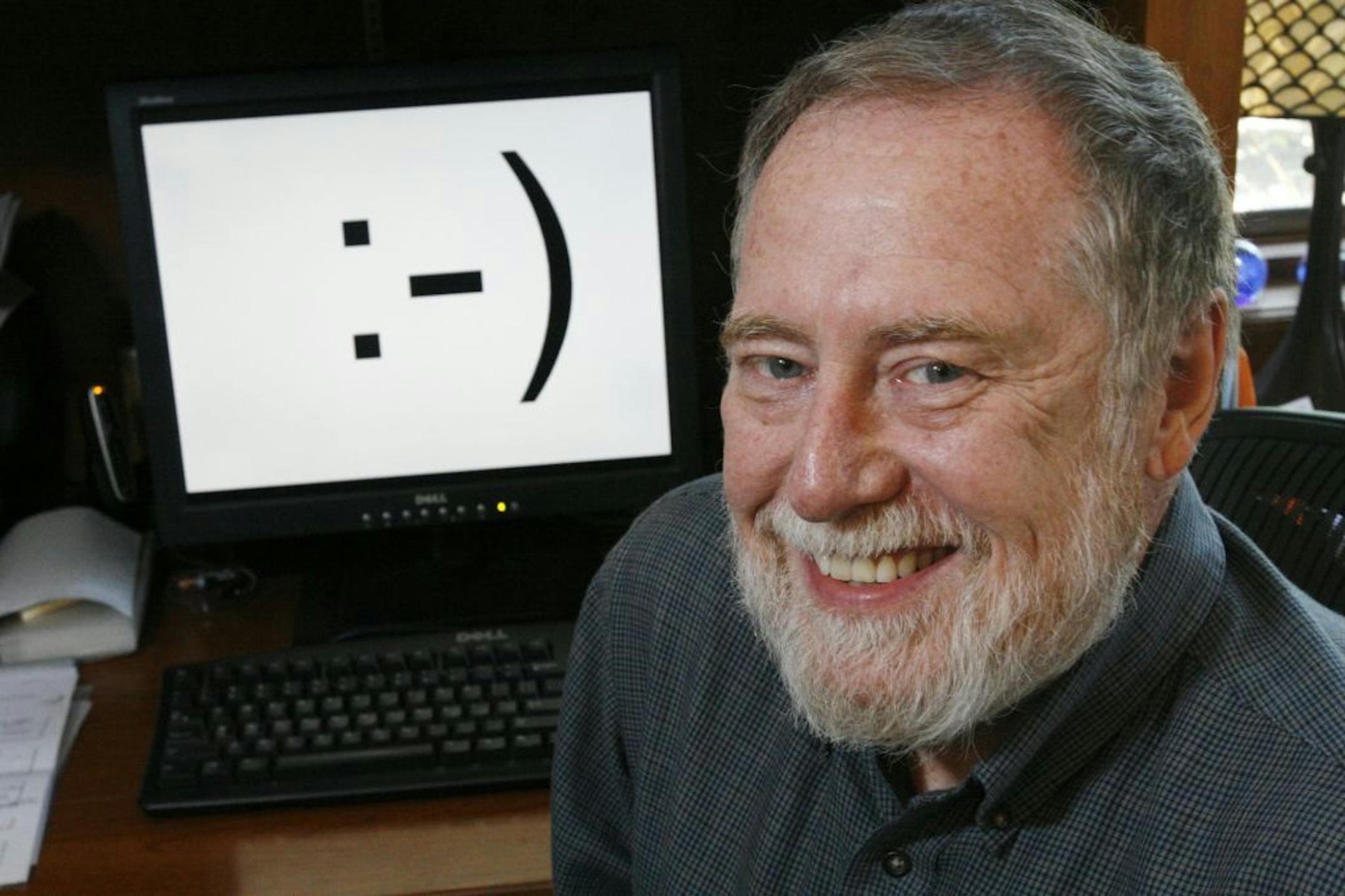 Carnegie Mellon professor Scott E. Fahlman is shown in his home office on Monday, Sept. 17, 2007, in Pittsburgh. Twenty-five years ago, three keystrokes _ a colon followed by a hyphen and a parenthesis _ were first used as a horizontal "smiley face" in a computer message by Fahlman, the university said. Fahlman posted the emoticon in a message to an online electronic bulletin board at 11:44 a.m. on Sept. 19, 1982.