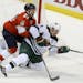 Minnesota Wild's Mikko Koivu (9), of Finland, and Florida Panthers Vincent Trocheck (21) battle for the puck during the first period of an NHL hockey 