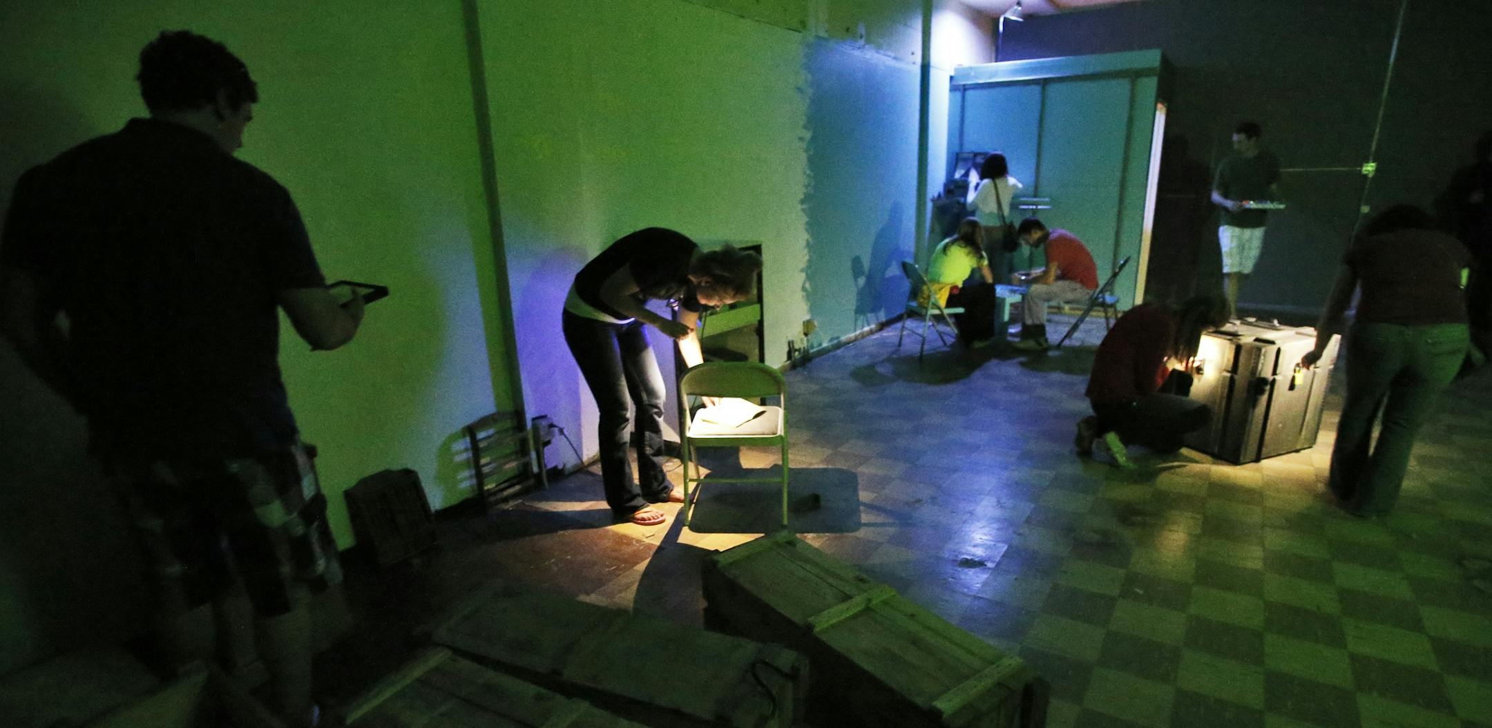 A group works on the various clues presented to them in an effort to find passage out of the riddle room.