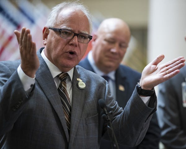 Governor Tim Walz left, Commissioner Larry Herke , and Patrick Kelly, director of the Minneapolis VA spoke during a news conference at the Minneapolis