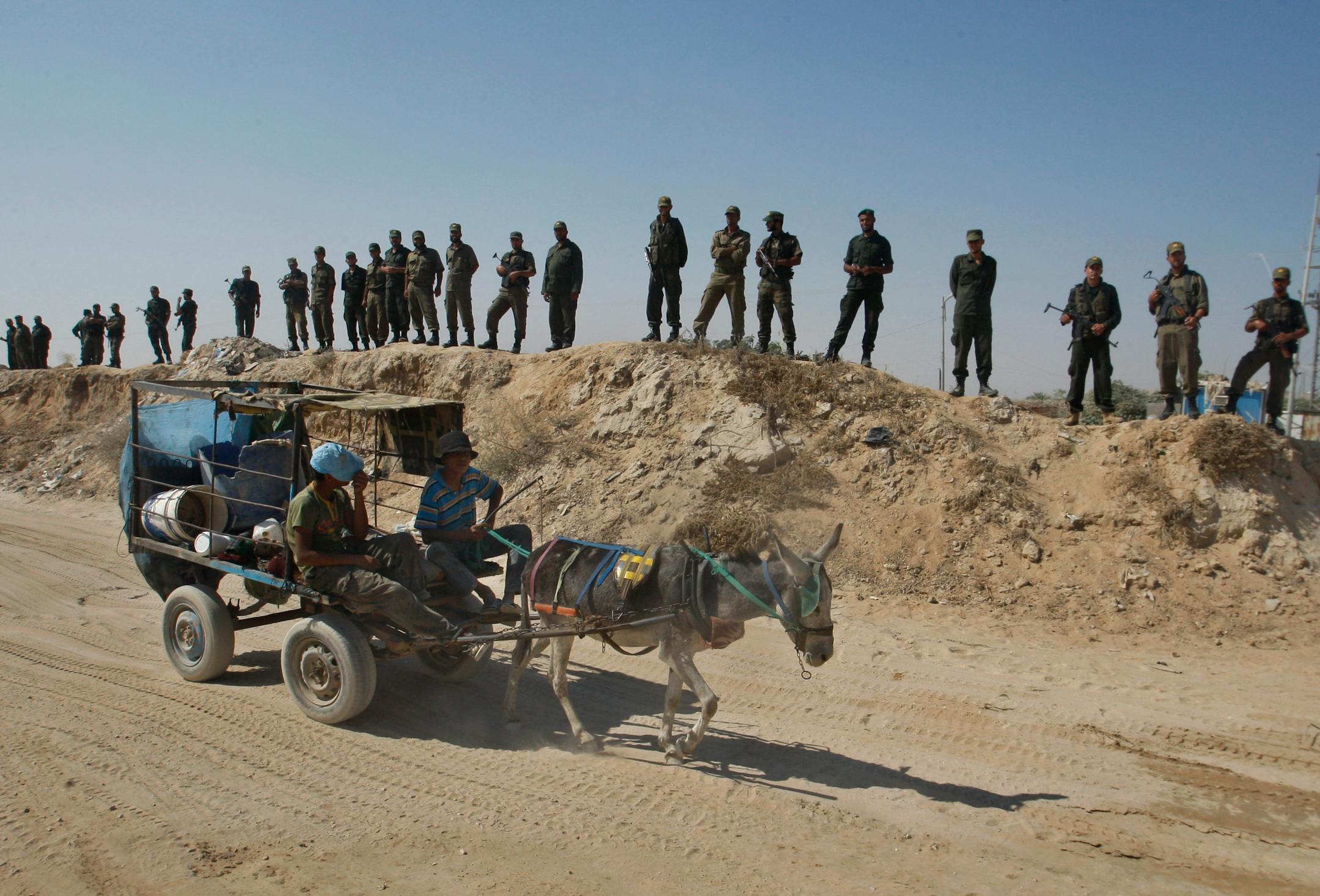 Palestinian Hamas border officers stand near the Egyptian-Gaza border during a protest against Egyptian policy on the smuggling tunnels in Rafah, southern Gaza Strip, Saturday, Sept. 15, 2012.