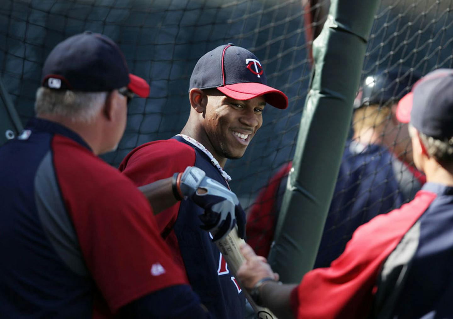 Minnesota Twins first round draft pick Byron Buxton, center, talks with manger Ron Gardenhire and hitting coach Joe Vara during batting practice before an interleague baseball game with the Philadelphia Phillies, Tuesday, June 12, 2012, in Minneapolis