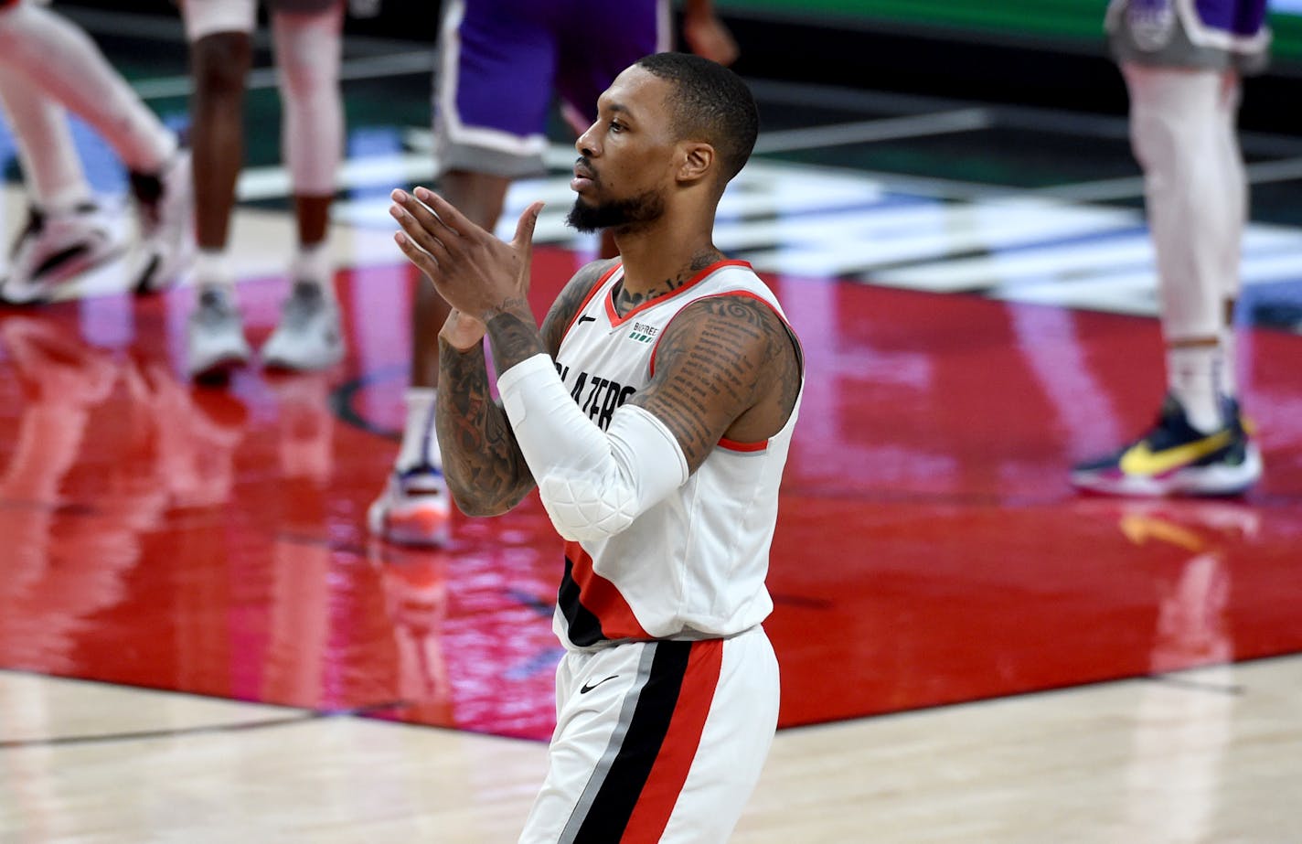 Portland Trail Blazers guard Damian Lillard reacts after hitting a shot late in fourth quarter of the team's NBA basketball game against the Sacramento Kings in Portland, Ore., Thursday, March 4, 2021. The Blazers won 123-119. (AP Photo/Steve Dykes)