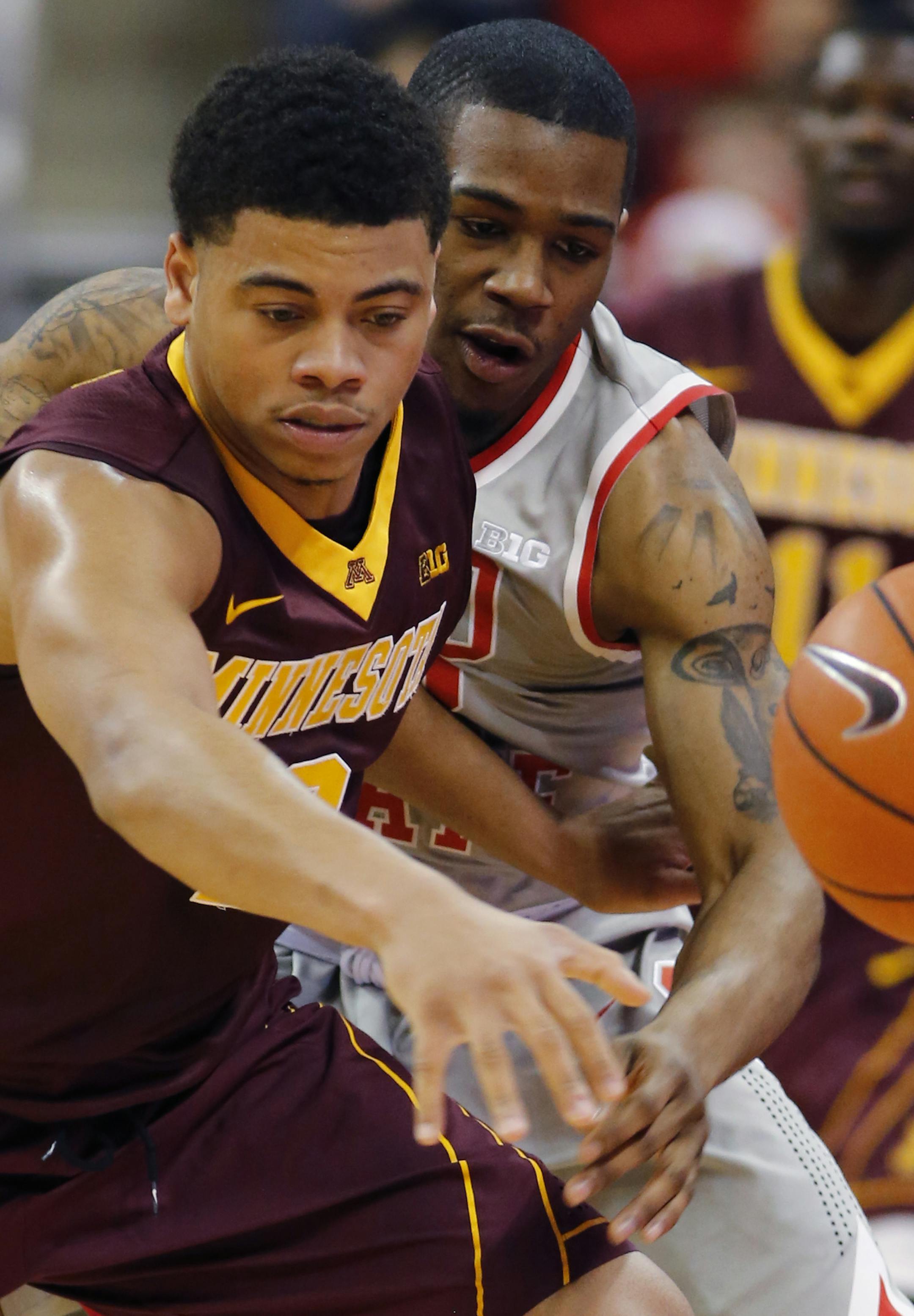 Ohio State's A.J. Harris, right, knocks the ball away from Minnesota's Nate Mason during the second half of an NCAA college basketball game, Wednesday, Dec. 30, 2015, in Columbus, Ohio. Ohio State beat Minnesota 78-63. (AP Photo/Jay LaPrete)