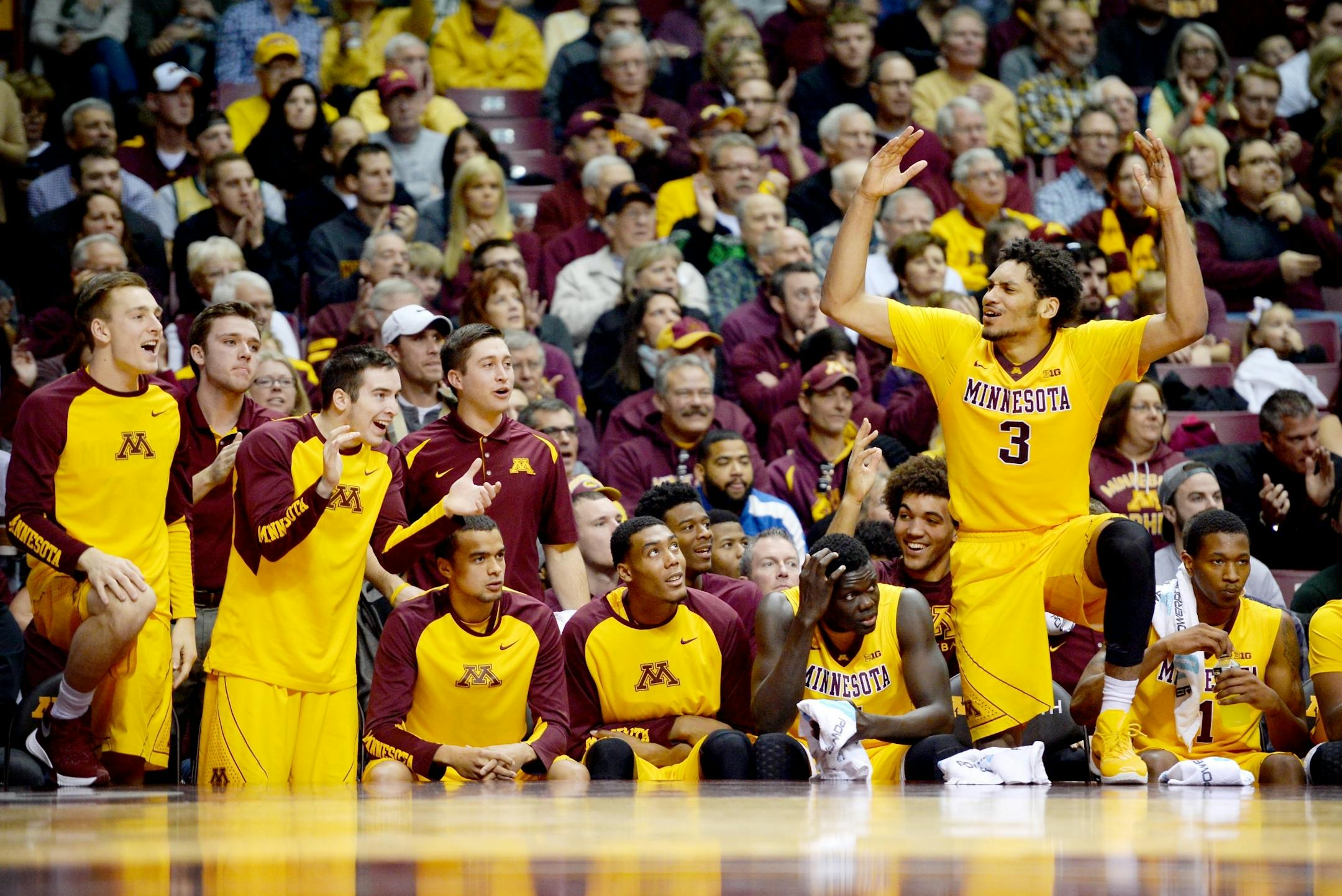 Players on the Minnesota Golden Gophers bench, including forward Jordan Murphy (3), erupted after a shot made by guard Kevin Dorsey (4) in the first half Saturday.