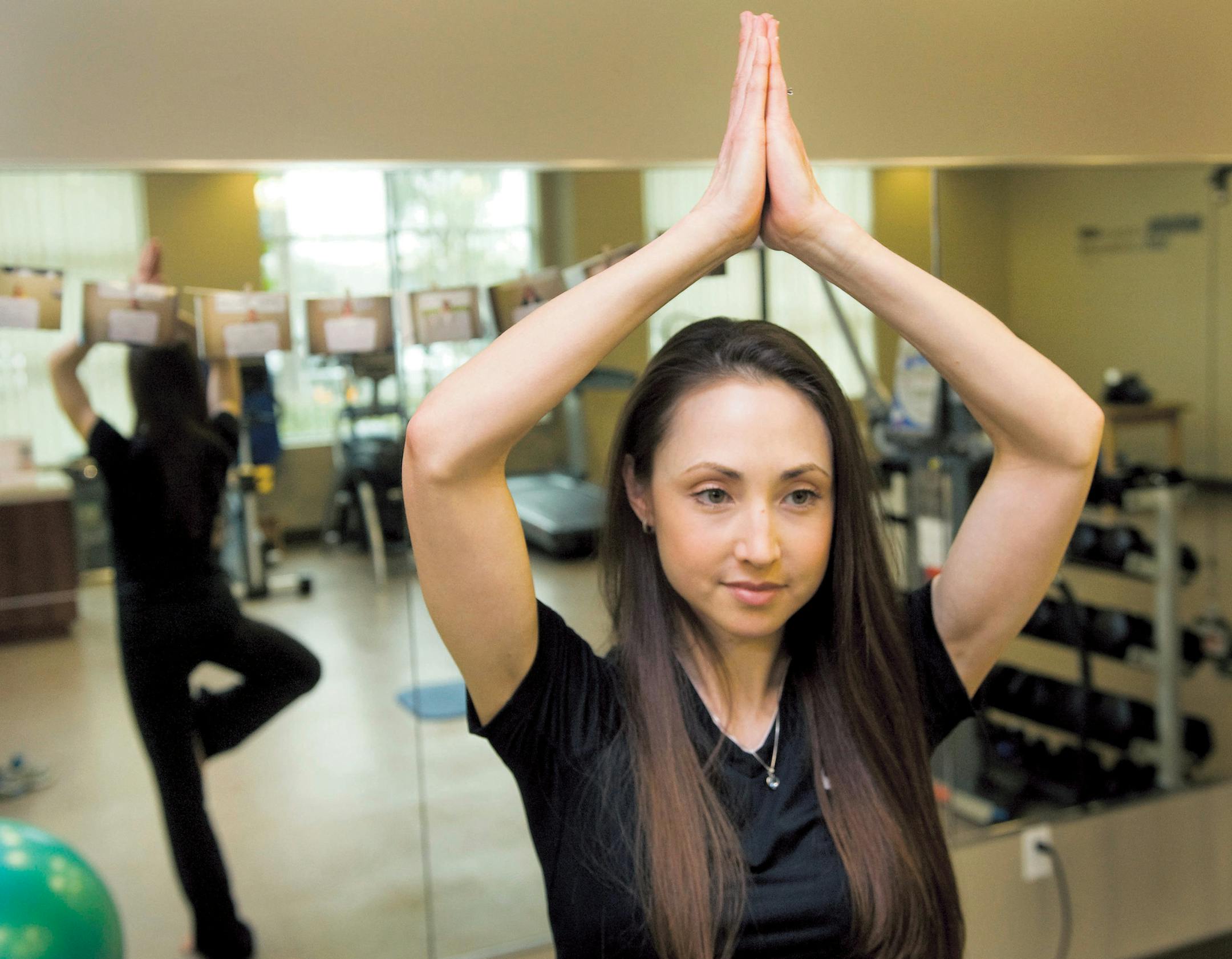 Personal trainer Robyn Baker does a yoga tree pose at the Healthfit 4 Life studio at Personal Care Physicians in Newport Beach, California. (Paul Bersebach/Orange County Register/MCT) ORG XMIT: 1135002