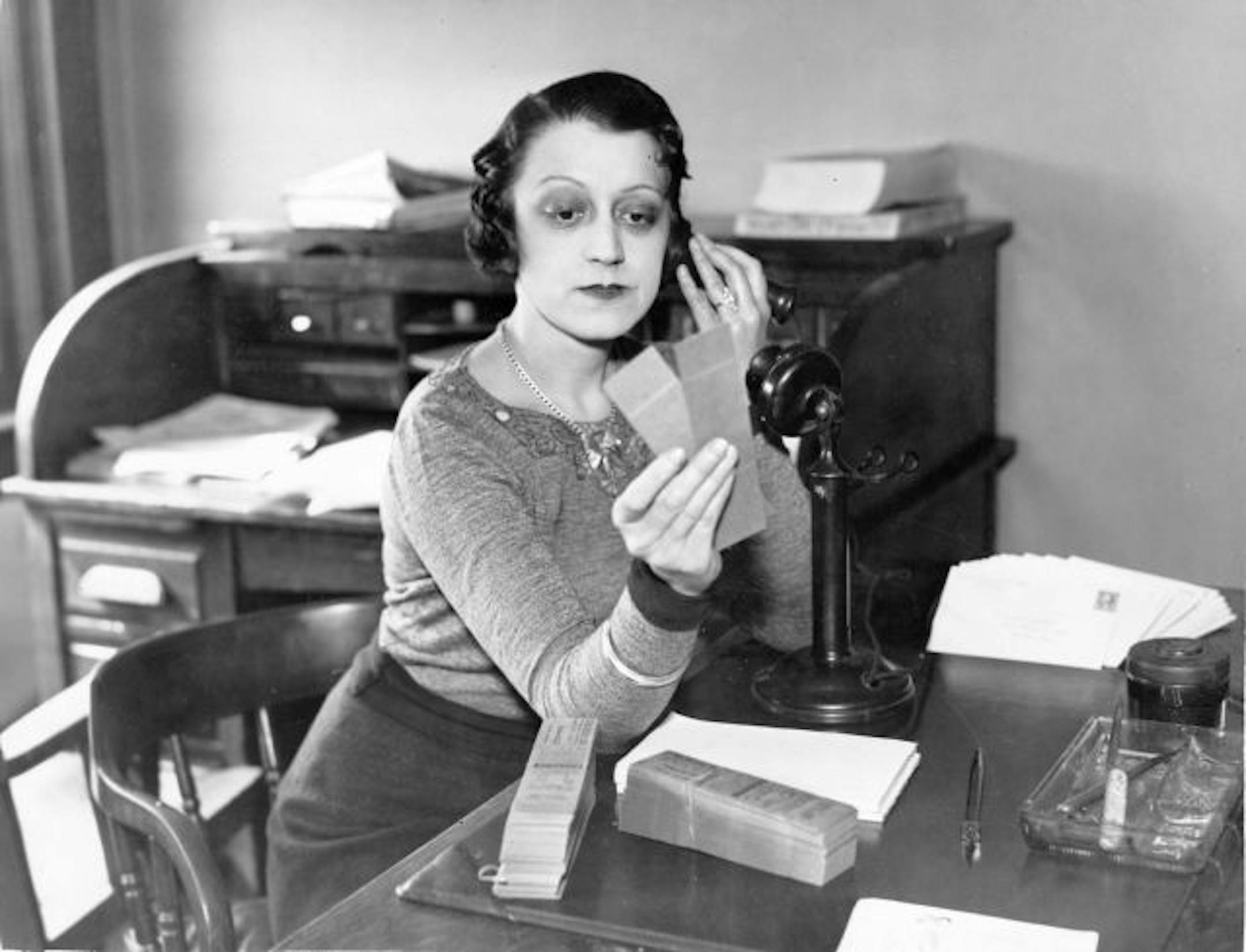 Miss B. M. Knorr on the telephone at an office desk, from the Minnesota Historical Society photograph collection.