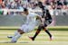 Los Angeles Galaxy forward Javier "Chicharito" Hernandez (14) moves the ball around Houston Dynamo defender Maynor Figueroa, right, during the first h