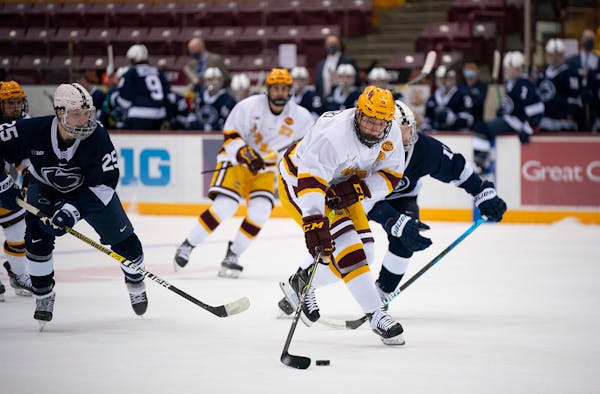 The Gophers Bryce Brodzinski tried to control the puck on a first period breakaway as he was pursued by Penn State� Chase McLane.
