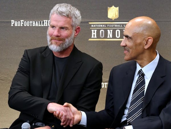 Former NFL players Brett Favre, left, and Tony Dungy, who will be inducted into the Pro Football Hall of Fame class of 2016, speak in the Hall of Fame