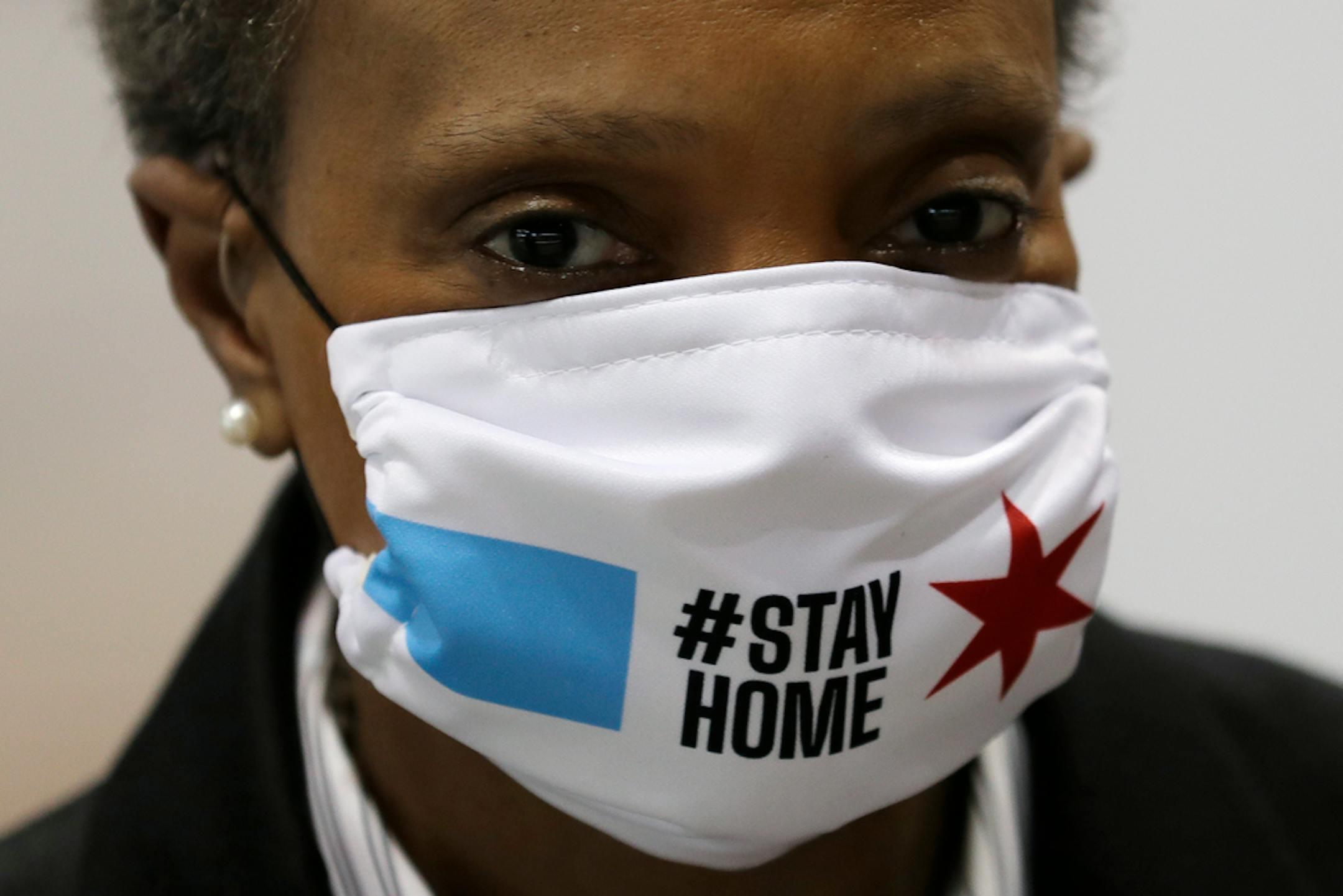Chicago Mayor Lori Lightfoot wears a mask as she attends a news conference in Hall A of the COVID-19 alternate site at McCormick Place in Chicago, Friday, April 10, 2020.