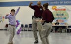 One of the students shows his dance moves with deputies as the Father/Daughter and Mother/Son Dance at Bonlee Elementary in Bear Creek. (Chatham Count