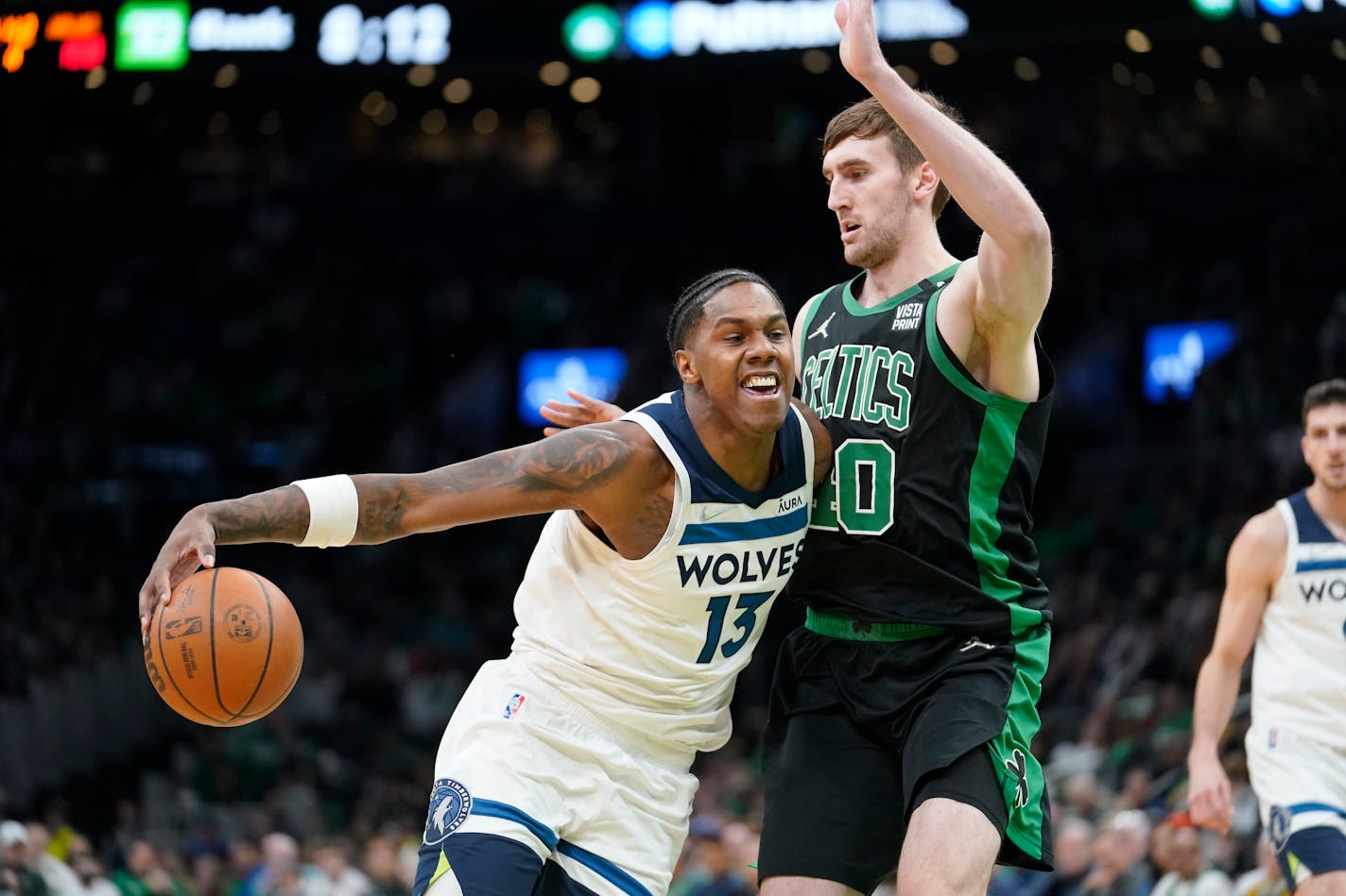 Minnesota Timberwolves forward Nathan Knight (13) tries to drive past Boston Celtics forward Luke Kornet (40) in the second half of an NBA basketball game, Sunday, March 27, 2022, in Boston. The Celtics won 134-112. (AP Photo/Steven Senne)