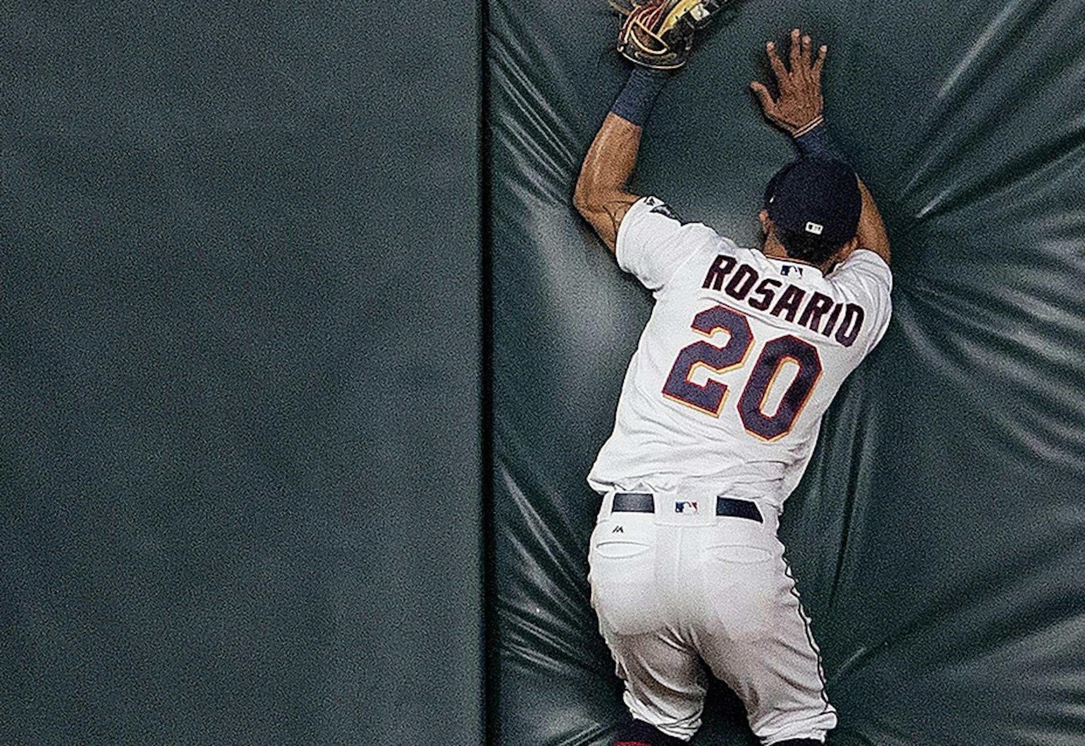 Twins left fielder Eddie Rosario (20) caught a ball at the fence hit by John Hicks to end the game.