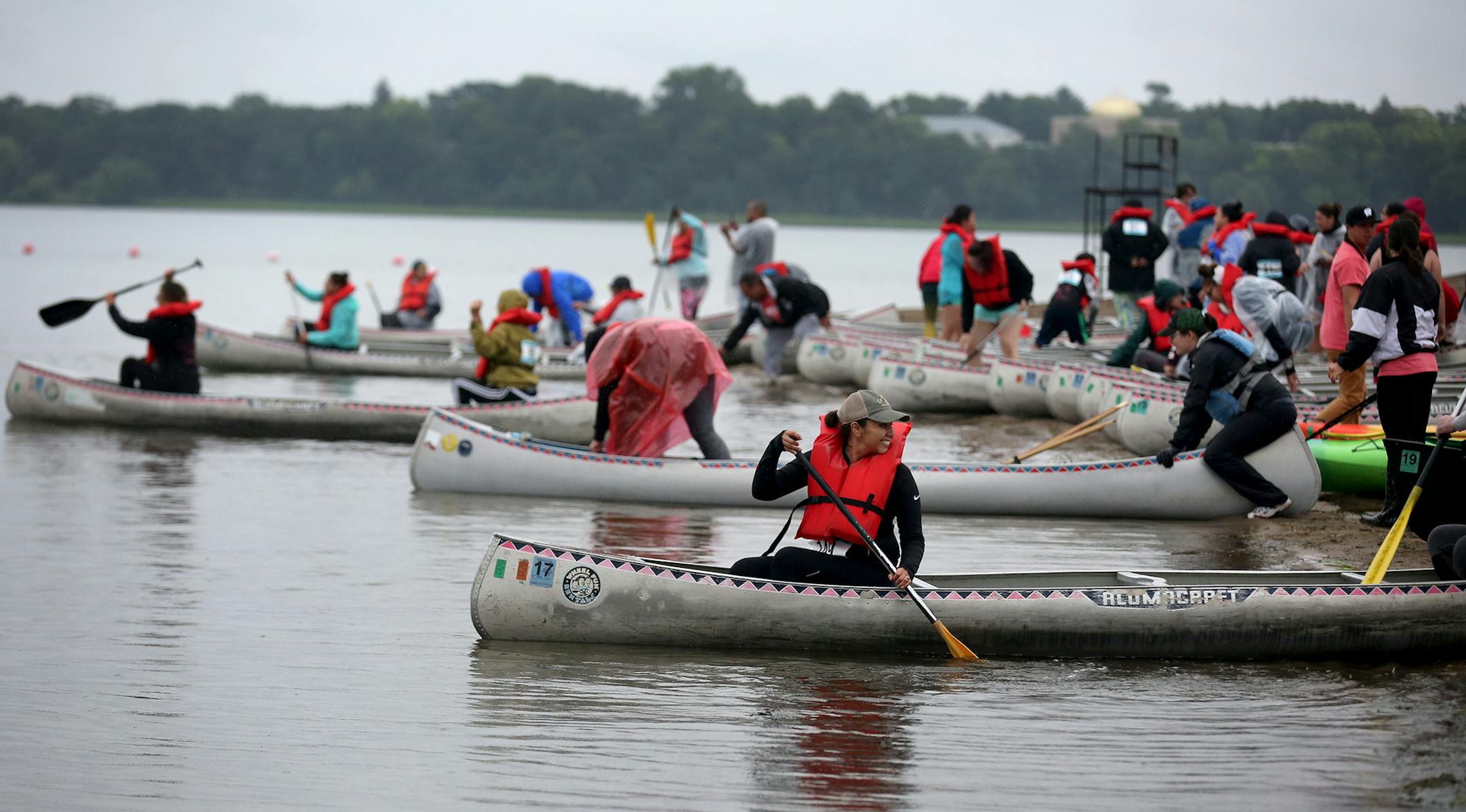 The first wave of women set off from shores of Bde Maka Ska/Lake Calhoun by canoe during the Kwe Strong Triathlon.