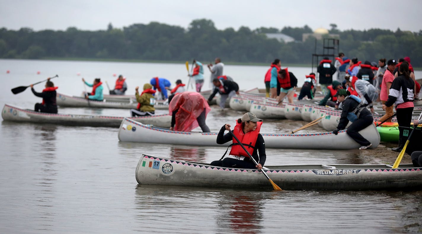 The first wave of women set off from shores of Bde Maka Ska/Lake Calhoun by canoe during the Kwe Strong Triathlon.