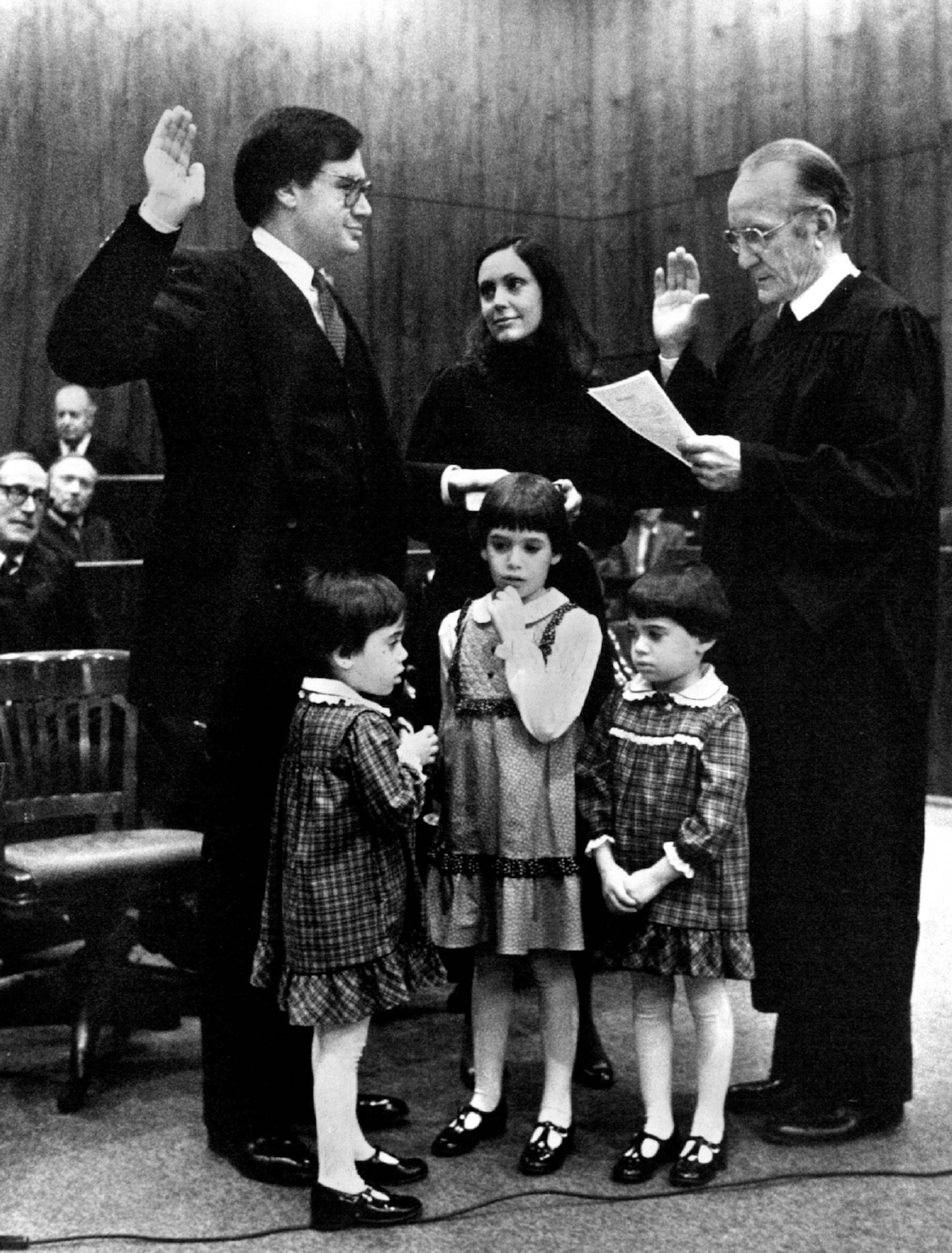 December 10, 19 81 James Rosenbaum, left, sworn in as U.S. Attorney. Federal Judge Miles Lord, rt. made it a family affair and brought the whole Rosenbaum family front & center. Wife Marilyn, center children Alexandra, 6, center, front twins Victoria, left and Catherine, rt., 4 yrs. old. December 11, 1981 Art Hager, Minneapolis Star Tribune