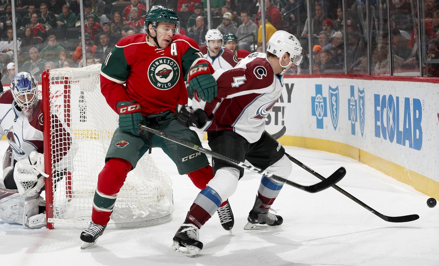 Wild winger Zach Parise and Colorado's Tyson Barrie fought for the puck in a Dec. 20 game. Parise is expected to return to action tonight after missing two games because of strep throat.