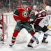 Wild winger Zach Parise and Colorado's Tyson Barrie fought for the puck in a Dec. 20 game. Parise is expected to return to action tonight after missin
