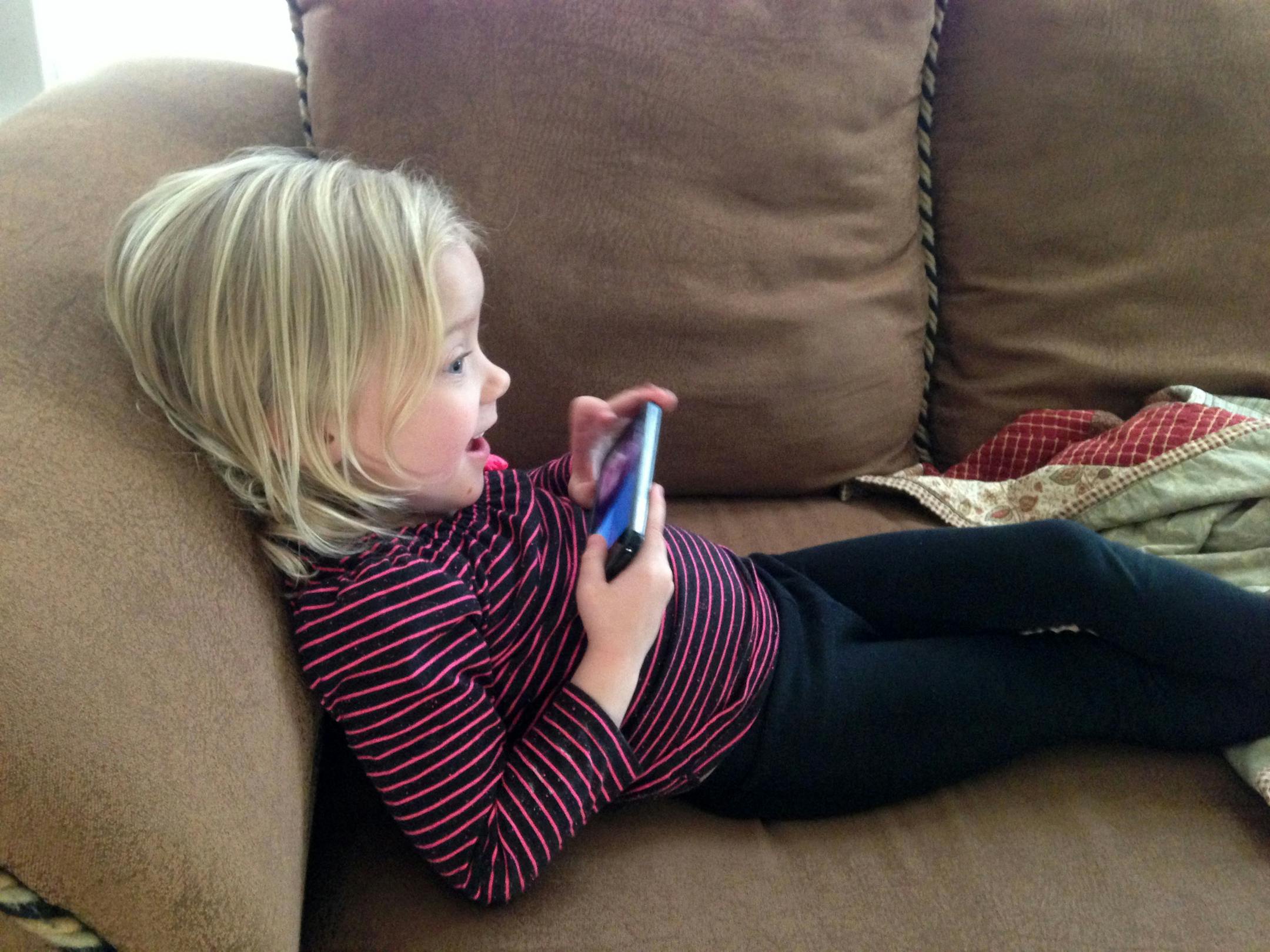 In this January 2014 photo provided by Brandi Koskie, her daughter, Paisley, 3, uses Facetime at her home in Wichita, Kansas to chat with her cousin, who lives in Oklahoma. An increasing number of parents of toddlers are finding their tech-savvy 2- and 3-year-old kids are obsessed with selfies (AP Photo/Brandi Koskie)