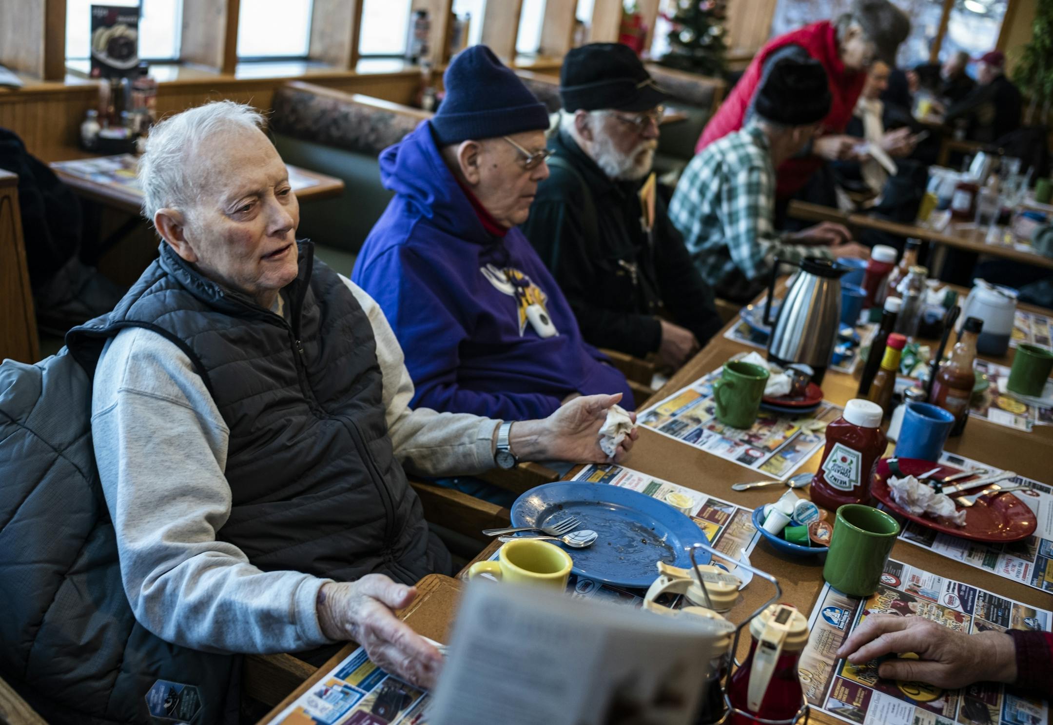 "I don't have anything against refugees," says Roger Hannigan,83 who doesn't understand why the county had to institute a ban on refugee resettlement while having breakfast with some friends at a local diner.