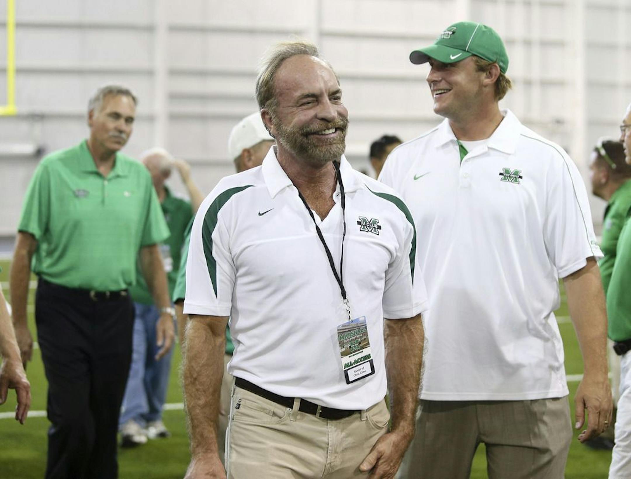 In this Sept. 6, 2014 photo shows Chris Cline, center, Chad Pennington, right, and Mike D'Antoni, left, arrive as Marshall University dedicates the new indoor practice facility as the Chris Cline Athletic Complex in Huntington, W.Va. Police in the Bahamas say a helicopter flying from Big Grand Cay island to Fort Lauderdale has crashed, killing seven Americans on board. None of the bodies recovered from the downed helicopter have been identified, but police Supt. Shanta Knowles told The Associate