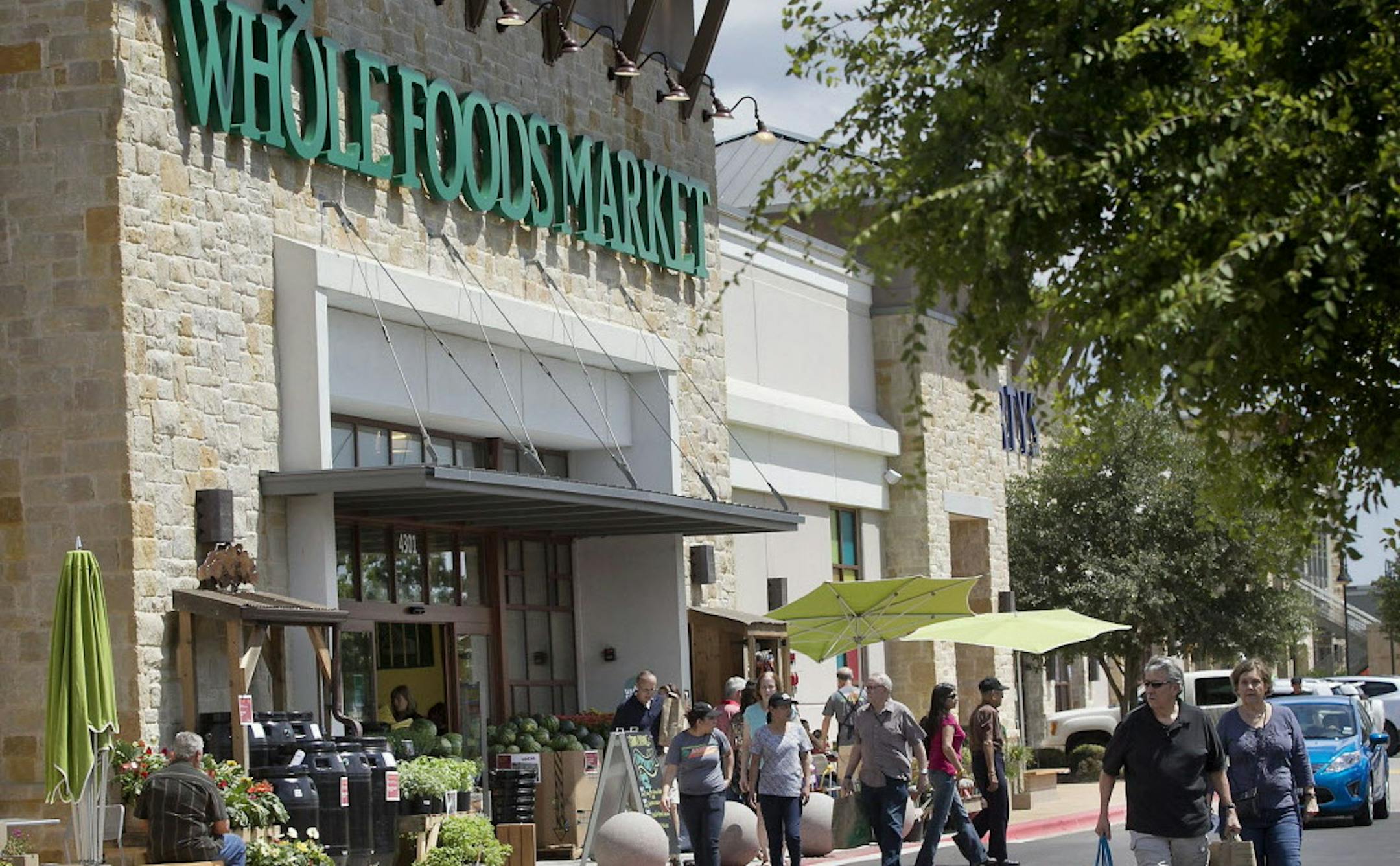 Whole Foods Market, headquartered in Austin, Texas, plans to add more than 30 stores this year, a record for the chain. But even as it expands it faces challenges from other grocers such as Trader Joes. Customers enter one of the chain's stores in Austin in 2012. (Laura Skelding/Austin American-Statesman/MCT) ORG XMIT: 1146596