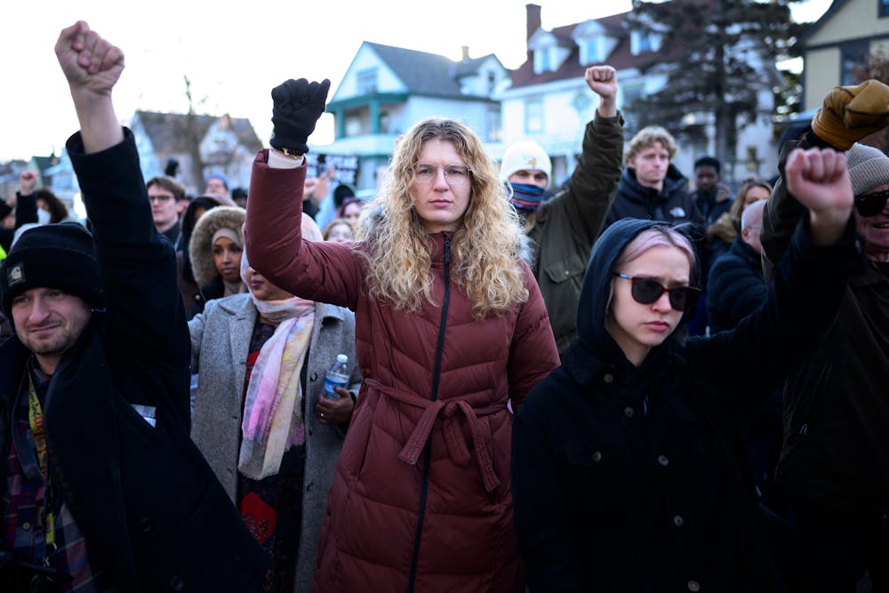 Rally goers raise their fists for Renee Good at her memorial on Jan. 9.
