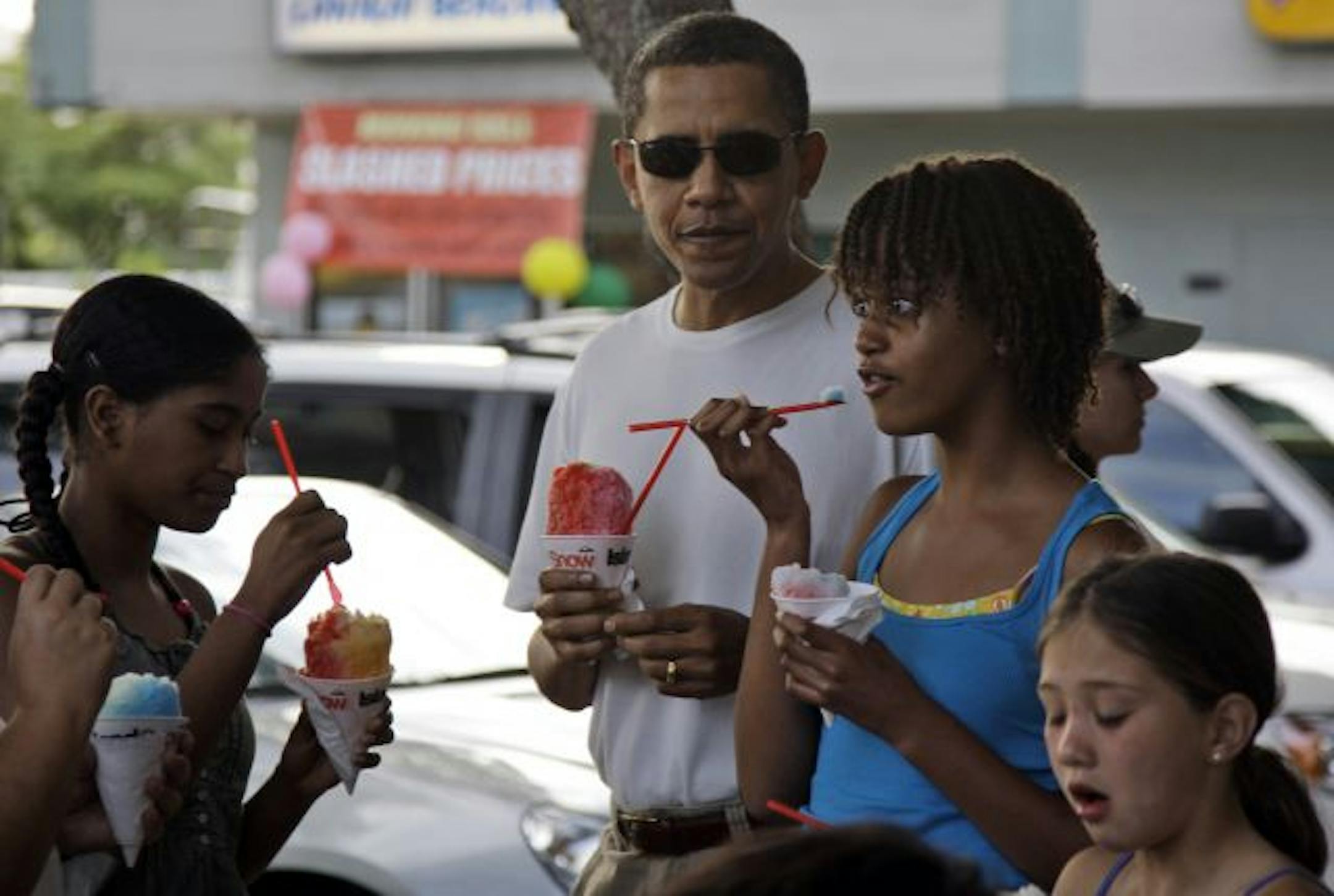 President Obama has shaved ice with his daughter Malia, 11 (second from right), and other family friends in Kailua, Hawaii, Jan. 1.
